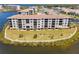 Waterfront condo building on a peninsula featuring stunning water views and lush landscaping at 8150 Brent St # 725, Port Richey, FL 34668