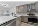Bright kitchen features a stainless steel appliance, marble counters, backsplash and gray cabinets at 8150 Brent St # 725, Port Richey, FL 34668
