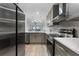 Contemporary kitchen showcases stainless steel appliances, light gray cabinets, and quartz countertops at 8150 Brent St # 725, Port Richey, FL 34668