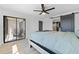 Spacious main bedroom with sliding glass doors, walk-in closet and modern ceiling fan at 8150 Brent St # 725, Port Richey, FL 34668