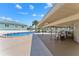 Community Pool with a covered area and outdoor seating, perfect for relaxing by the water at 8150 Brent St # 725, Port Richey, FL 34668