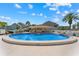 Community pool and recreation area with clear blue water, and lounge area at 8150 Brent St # 725, Port Richey, FL 34668