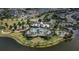 Aerial view of the community pool, clubhouse, and lake at 9133 Warm Springs Cir, Parrish, FL 34219