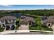 Aerial view of home near a pond featuring lush greenery in a well-maintained community at 9133 Warm Springs Cir, Parrish, FL 34219