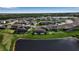 Wide aerial perspective revealing a community with homes backing onto a tranquil pond at 9133 Warm Springs Cir, Parrish, FL 34219