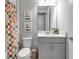 Bathroom featuring vanity with sink, toilet, and colorful shower curtain with coordinated decor at 9133 Warm Springs Cir, Parrish, FL 34219
