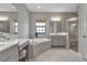 Bathroom featuring soaking tub, double vanity, tile floors and tiled shower at 9133 Warm Springs Cir, Parrish, FL 34219