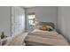 Cozy bedroom featuring neutral tones, closet doors, plush rug, and natural light from the window at 9133 Warm Springs Cir, Parrish, FL 34219