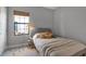 Well-lit bedroom with a soft gray palette, featuring a playful decor and a comfy bed with throw blanket at 9133 Warm Springs Cir, Parrish, FL 34219