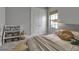 Bright bedroom with white closet doors, decorated with toys and shelving for storage and display at 9133 Warm Springs Cir, Parrish, FL 34219