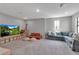 Spacious bonus room with TV, seating, and a large carpeted area for entertainment and relaxation at 9133 Warm Springs Cir, Parrish, FL 34219