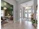 Bright entryway with a stylish console table, chandelier, and a view into the adjacent room at 9133 Warm Springs Cir, Parrish, FL 34219