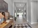 Inviting entryway featuring a console table with decorative items and a view into the open-concept living area at 9133 Warm Springs Cir, Parrish, FL 34219