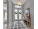Grand entryway with double doors, decorative chandelier, and a stylish console table with decor at 9133 Warm Springs Cir, Parrish, FL 34219