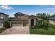Charming home featuring a beautiful brick driveway and a meticulously landscaped front yard at 9133 Warm Springs Cir, Parrish, FL 34219