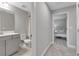 Hallway view showcasing a bathroom, bedroom and an ensuite bathroom at 9133 Warm Springs Cir, Parrish, FL 34219
