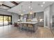 Large kitchen with gray cabinets, a big center island with seating, and stainless steel appliances at 9133 Warm Springs Cir, Parrish, FL 34219