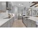 Spacious kitchen featuring gray cabinetry, modern appliances, and a large island with a sink at 9133 Warm Springs Cir, Parrish, FL 34219