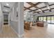Spacious living area with coffered ceiling, open floor plan, and seamless indoor-outdoor flow at 9133 Warm Springs Cir, Parrish, FL 34219