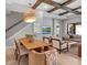 Open-concept living space with dining area, coffered ceiling, and sliding doors to the outside at 9133 Warm Springs Cir, Parrish, FL 34219