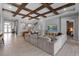 Bright living room with wood beam ceiling, tile floors and a comfortable sectional sofa at 9133 Warm Springs Cir, Parrish, FL 34219