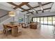 Expansive living area with coffered ceiling, dining space, and panoramic views of the water at 9133 Warm Springs Cir, Parrish, FL 34219