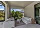 Cozy outdoor patio featuring comfortable seating and views of lush tropical landscaping at 9133 Warm Springs Cir, Parrish, FL 34219