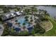 Aerial view of the community pool with palm trees and lounge areas at 9133 Warm Springs Cir, Parrish, FL 34219