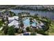 Aerial view of the community pool with lounge areas and lakeside views at 9133 Warm Springs Cir, Parrish, FL 34219