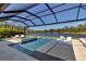 Stunning pool area with a relaxing spa and scenic lake views, perfect for outdoor enjoyment at 9133 Warm Springs Cir, Parrish, FL 34219