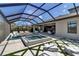 The covered patio has a hot tub, lounge chairs in the water, and artificial grass accents at 9133 Warm Springs Cir, Parrish, FL 34219