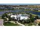 Aerial view of the community pool and clubhouse nestled near a lake at 9133 Warm Springs Cir, Parrish, FL 34219