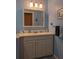 Bathroom with blue walls, a large sink, and a wide mirror cabinet at 9208 37Th N St, Pinellas Park, FL 33782
