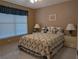 Comfortable bedroom features a ceiling fan and a bright window, creating a relaxing atmosphere at 9208 37Th N St, Pinellas Park, FL 33782