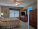 Spacious bedroom with a ceiling fan, window and doorways to the bathroom and hallway at 9208 37Th N St, Pinellas Park, FL 33782