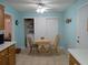 Bright dining area featuring tile floors, a ceiling fan, and a table with chairs adjacent to the kitchen space at 9208 37Th N St, Pinellas Park, FL 33782