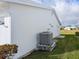 Exterior view showcases the home's well-maintained white facade and efficient AC unit at 9208 37Th N St, Pinellas Park, FL 33782