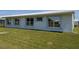 Clean exterior featuring a well-manicured lawn and pristine white facade, offering a serene view at 9208 37Th N St, Pinellas Park, FL 33782