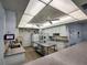 Commercial kitchen with white cabinets, stainless steel appliances, countertops, lighting, and a vinyl floor at 9208 37Th N St, Pinellas Park, FL 33782