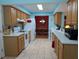 Bright kitchen boasts light wood cabinets, white appliances, and ceramic tile flooring at 9208 37Th N St, Pinellas Park, FL 33782