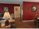 Comfortable living room featuring a red accent wall and wood-style flooring at 9208 37Th N St, Pinellas Park, FL 33782