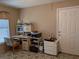 The functional home office features patterned tile floors, a window with blinds, and multiple work surfaces at 9208 37Th N St, Pinellas Park, FL 33782