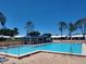 A refreshing pool and a beautiful patio area is surrounded by a clear blue sky, perfect for outdoor relaxation at 9208 37Th N St, Pinellas Park, FL 33782