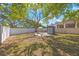 Large backyard with a mature tree, shed, and white vinyl fence at 6711 3Rd N St, St Petersburg, FL 33702