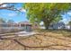 Spacious backyard featuring a storage shed, concrete patio, and large tree providing ample shade at 6711 3Rd N St, St Petersburg, FL 33702