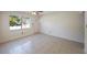 Bright room featuring tiled floors, neutral paint, and natural light streaming through the window and front door at 6711 3Rd N St, St Petersburg, FL 33702