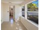 Bright room with an entrance to the laundry room featuring tiled floors and natural light streaming through the windows at 6711 3Rd N St, St Petersburg, FL 33702