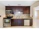 Modern kitchen features stainless steel appliances, stylish mosaic backsplash, and dark wood cabinetry at 6711 3Rd N St, St Petersburg, FL 33702