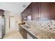 Well-lit kitchen featuring granite counters, stainless steel appliances, and a stylish backsplash at 6711 3Rd N St, St Petersburg, FL 33702