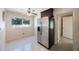 The kitchen offers an eat-in space with natural light, ceiling fan, and stainless steel refrigerator at 6711 3Rd N St, St Petersburg, FL 33702